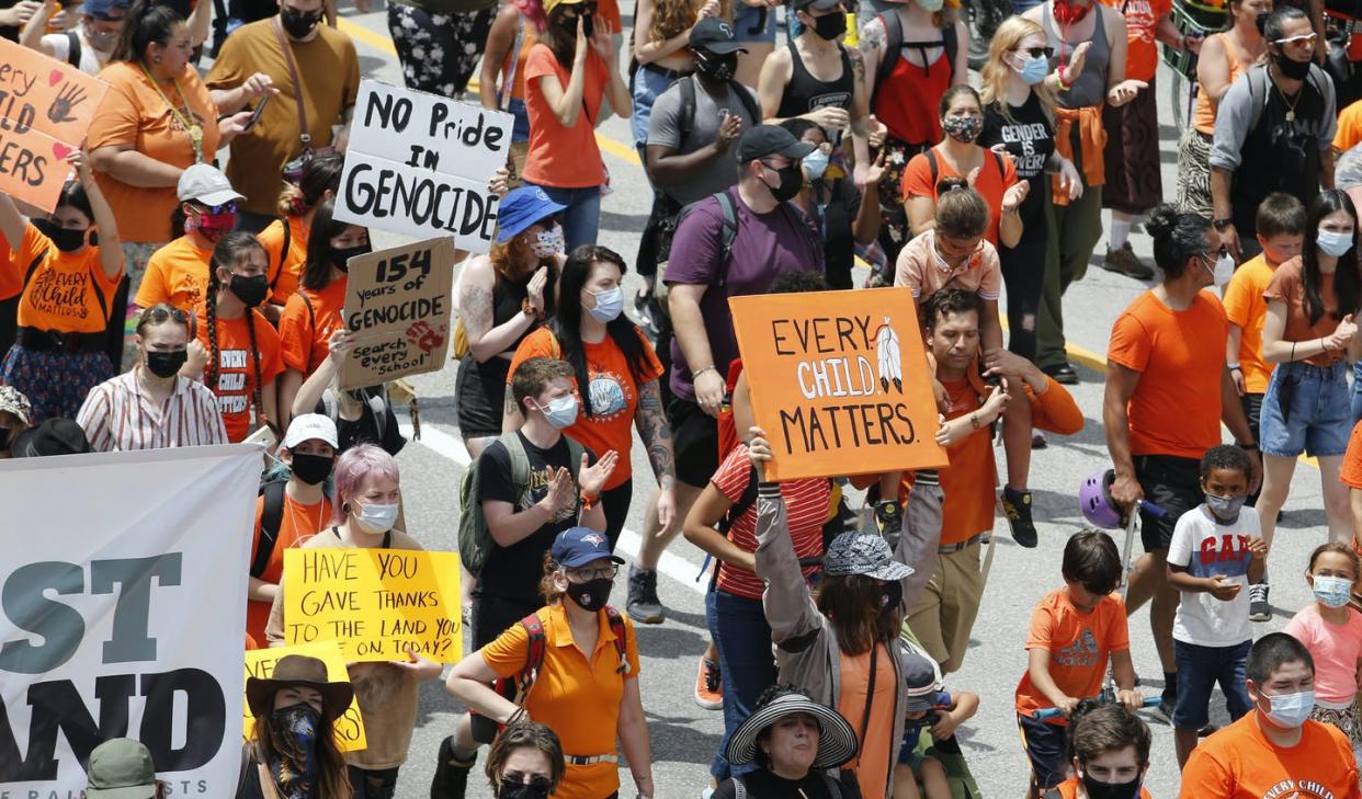 <span class="caption">Protesters march to Parliament Hill in Ottawa in response to the discovery of unmarked Indigenous graves at residential schools on July 1, 2021. </span> <span class="attribution"><span class="source">THE CANADIAN PRESS/ Patrick Doyle </span></span>