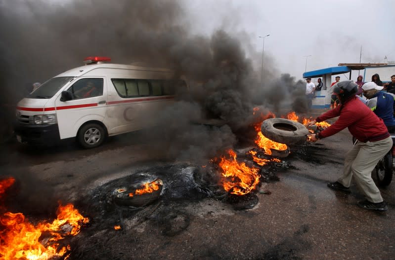 Iraqi protesters burn tires during the ongoing anti-government protests in Basra