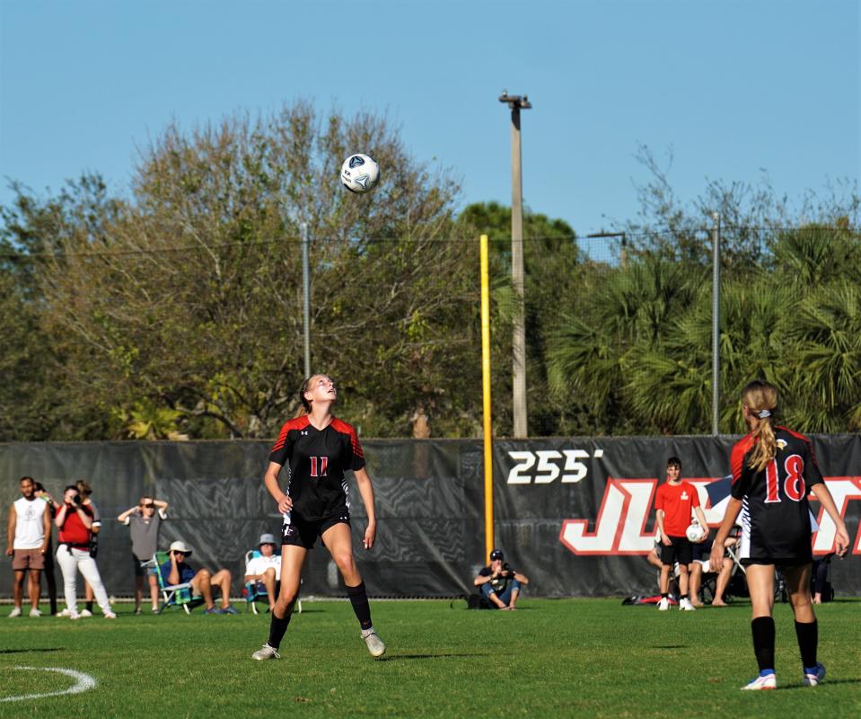 Jupiter Christian's Iris Gardner heads the ball against Pine School during the District 8-2A championship match on Tuesday, Jan. 31, 2023 in Jupiter. Pine School won the match 3-2.