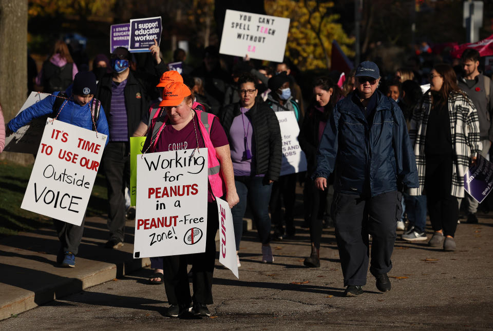 Members of CUPE education workers and other supporters amass at Queens Park to protest a day after the Provincial Government enacted the Not Withstanding Clause of the Canadian Constitution to legislate a contract on the union