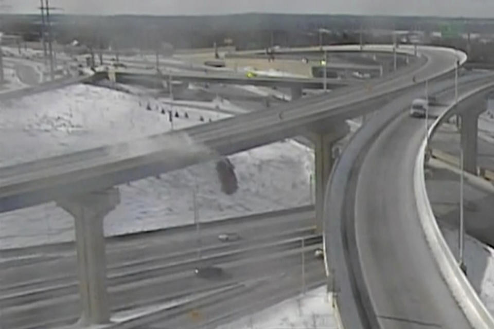 In this Saturday, Feb. 6, 2021 image from video made available by the Wisconsin Department of Transportation, a pickup truck falls off an elevated highway in Milwaukee. After plunging about 70 feet (21 meters) off the slippery interchange exit ramp, Richard Lee Oliver said he feels thankful to be alive. (Wisconsin Department of Transportation via AP)