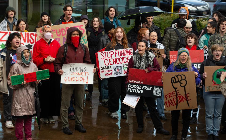 Pro-Palestine and climate change protestors rally Tuesday outside a meeting of the UO Board of Trustees.