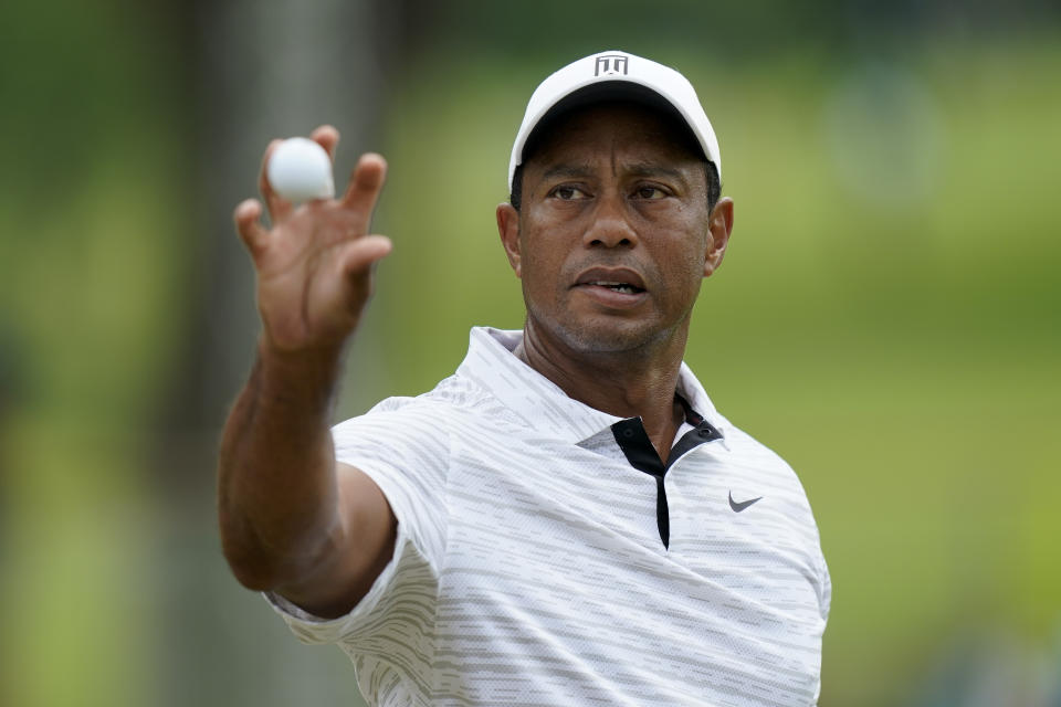 Tiger Woods catches a ball on the driving range before a practice round for the PGA Championship golf tournament, Tuesday, May 17, 2022, in Tulsa, Okla. (AP Photo/Eric Gay)