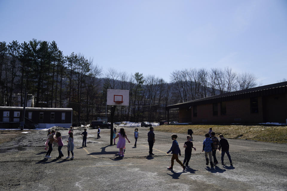 Students play outside during recess at the Panther Valley Elementary School, Thursday, March 11, 2021, in Nesquehoning, Pa. On May 26, 2020, former student, 9-year-old Ava Lerario; her mother, Ashley Belson, and Ava's father, Marc Lerario were found fatally shot inside their home. (AP Photo/Matt Slocum)