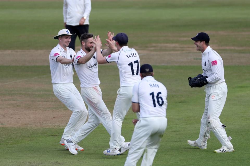 Chris Woakes is congratulated by team-mates for dismissing Warwickshire’s Jack Leach  (PA Wire)