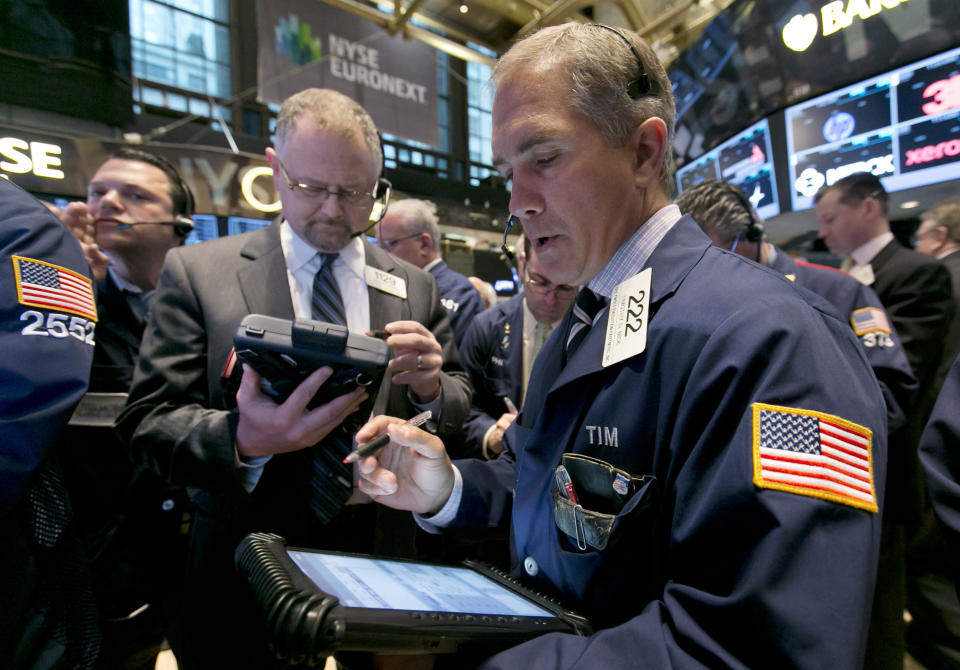 Trader Timothy Nick, right, works on the floor of the New York Stock Exchange, Tuesday, April 8, 2014. Stocks were mixed in early trading on Tuesday after a three-day slump. Investors will start to focus on company earnings this week. (AP Photo/Richard Drew)