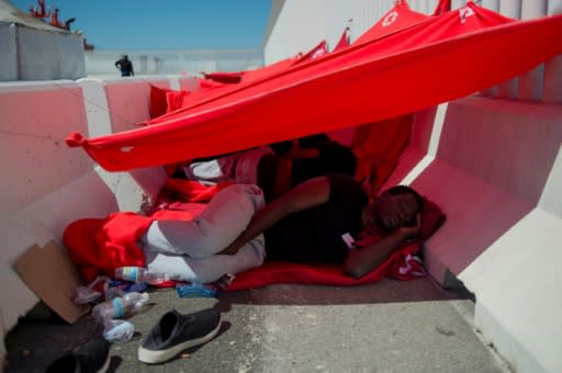 With police stations and makeshift emergency shelters full, many migrants have been forced to sleep inside a rescue boat docked in Algeciras, or on the pavement beside it