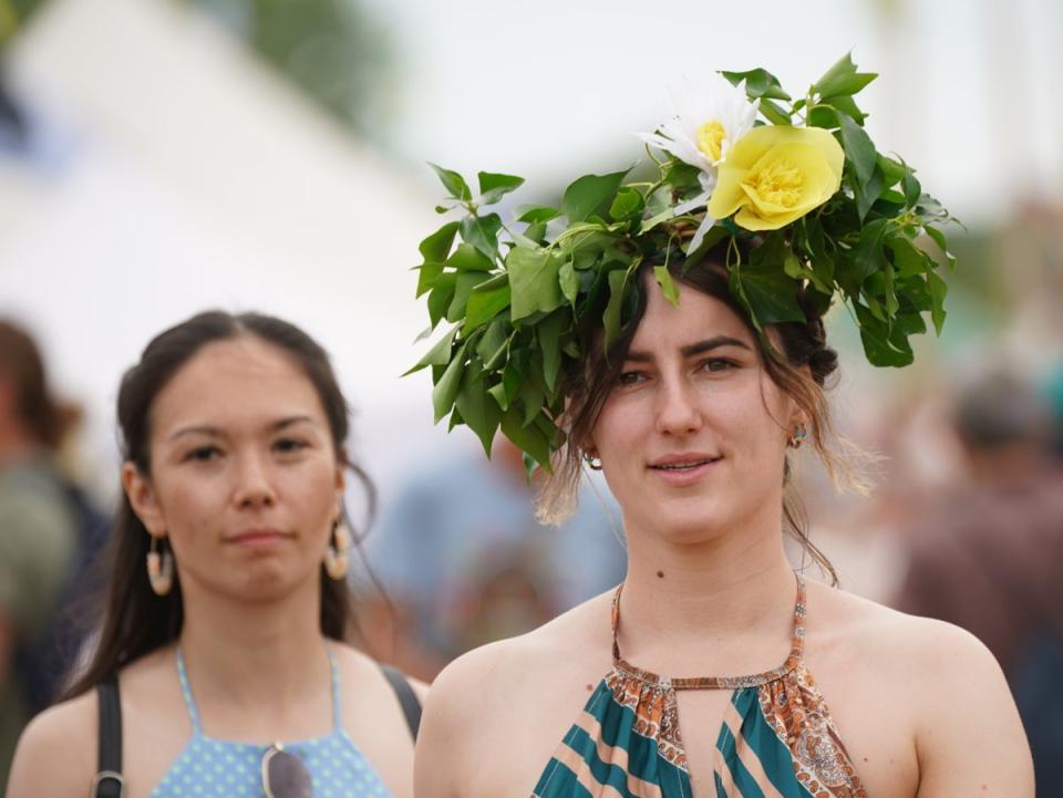 Some revellers wore fancy head-dressings to celebrate Glastonbury’s return (Yui Mok/PA) (PA Wire)