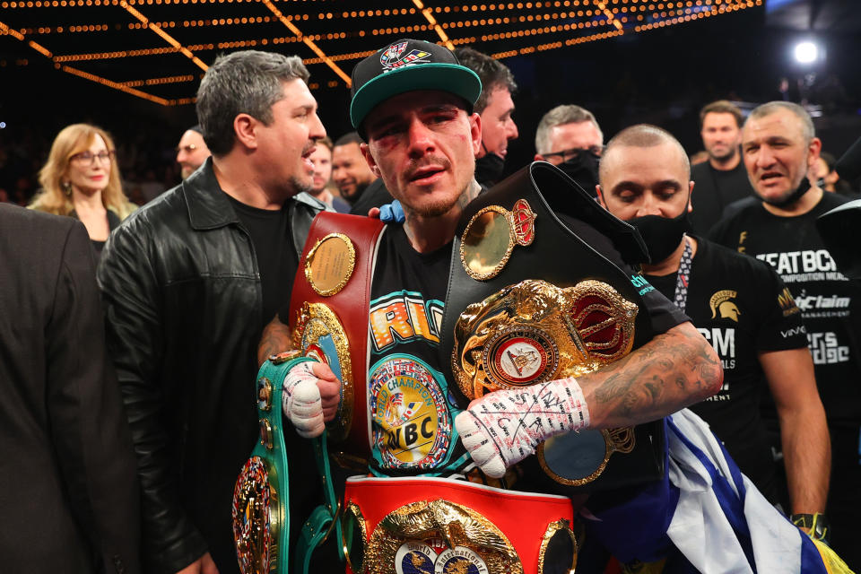 Pictured here, George Kambosos Jr poses with the lightwweight belts he won after beating Teofimo Lopez in New York.