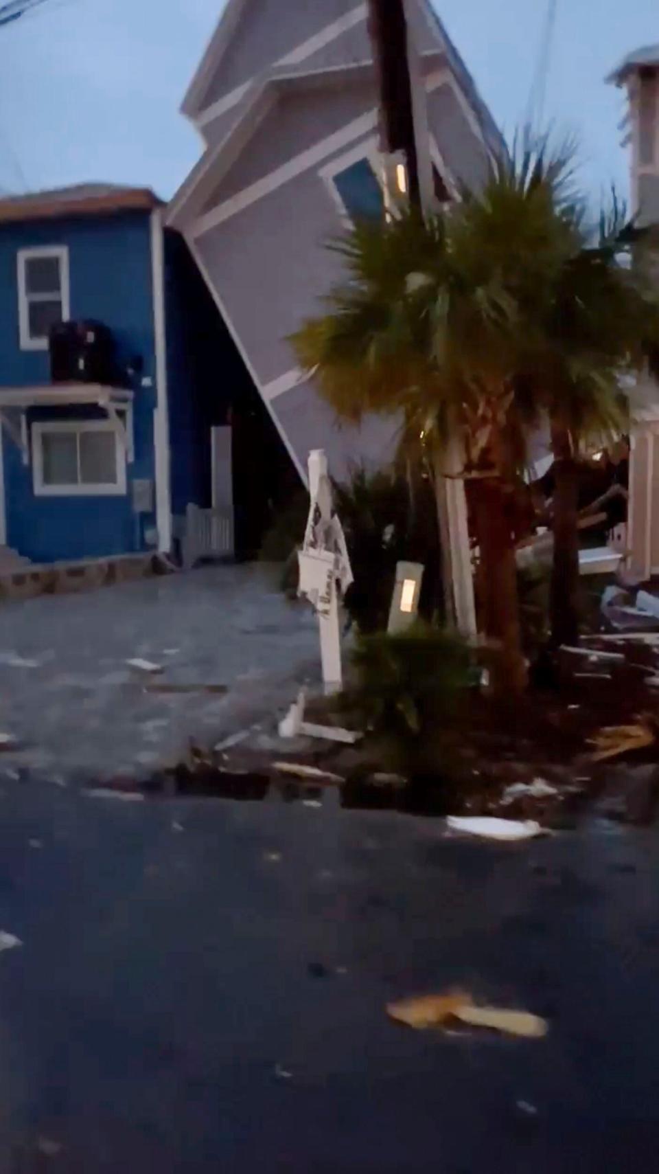 A house is damaged after a storm passed the area on Tuesday, Jan. 9, 2024 in Panama City, Fla. A sprawling storm hit the South with tornado warnings and high winds that blew roofs off homes, flipped over campers and tossed about furniture in Florida on Tuesday. Another storm brought cities across the Midwest to a standstill with more than half a foot of snow, stranding people on highways as it headed to the Northeast. (Richmon Moore via AP)