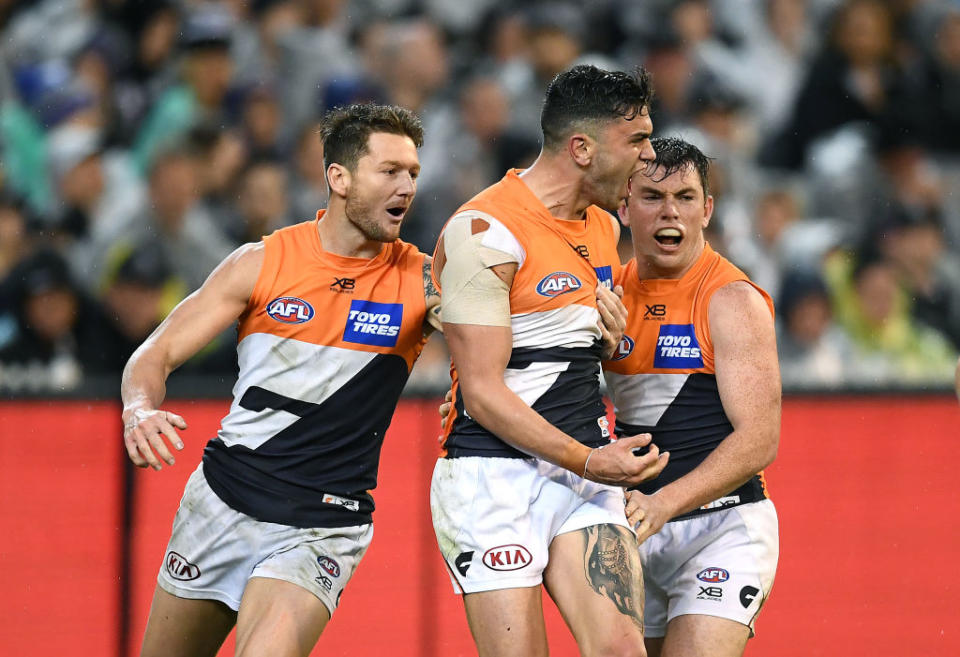 Tim Taranto of the Giants is congratulated by team mates after kicking a goal during the AFL Preliminary Final match. (Photo by Quinn Rooney/Getty Images)