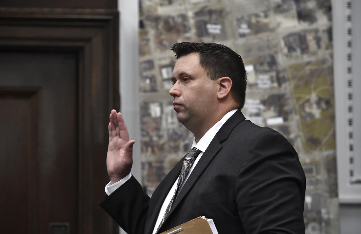 James Armstrong, of the state crime lab, is sworn in before given testimony during Kyle Rittenhouse's trial at the Kenosha County Courthouse in Kenosha, Wis., on Tuesday, Nov. 9, 2021. James Armstrong, of the state crime lab, points to drone video he digitally enlarged during Kyle Rittenhouse's trial at the Kenosha County Courthouse in Kenosha, Wis., on Tuesday, Nov. 9, 2021. Rittenhouse is accused of killing two people and wounding a third during a protest over police brutality in Kenosha, last year. (Sean Krajacic/The Kenosha News via AP, Pool)