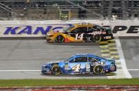 May 11, 2019; Kansas City, KS, USA; NASCAR Cup Series driver Kevin Harvick (4) races Clint Bowyer (14) during the Digital Ally 400 at Kansas Speedway. Mandatory Credit: Jasen Vinlove-USA TODAY Sports