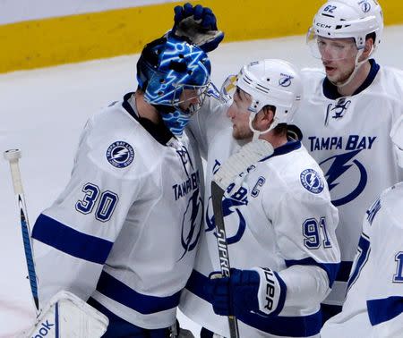Tampa Bay Lightning goalie Ben Bishop (30) and teammate forward Steven Stamkos (91) celebrate their victory against the Montreal Canadiens in game two of the second round of the 2015 Stanley Cup Playoffs at the Bell Centre. Mandatory Credit: Eric Bolte-USA TODAY Sports