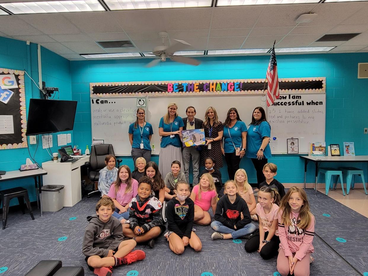 In this photo from October 2021, Bob Davis, president of the Lodging and Hospitality Association of Volusia County, and a representative from the Daytona Beach International Airport present Indian River Elementary students with model jet engines through an adopt-a-school program.