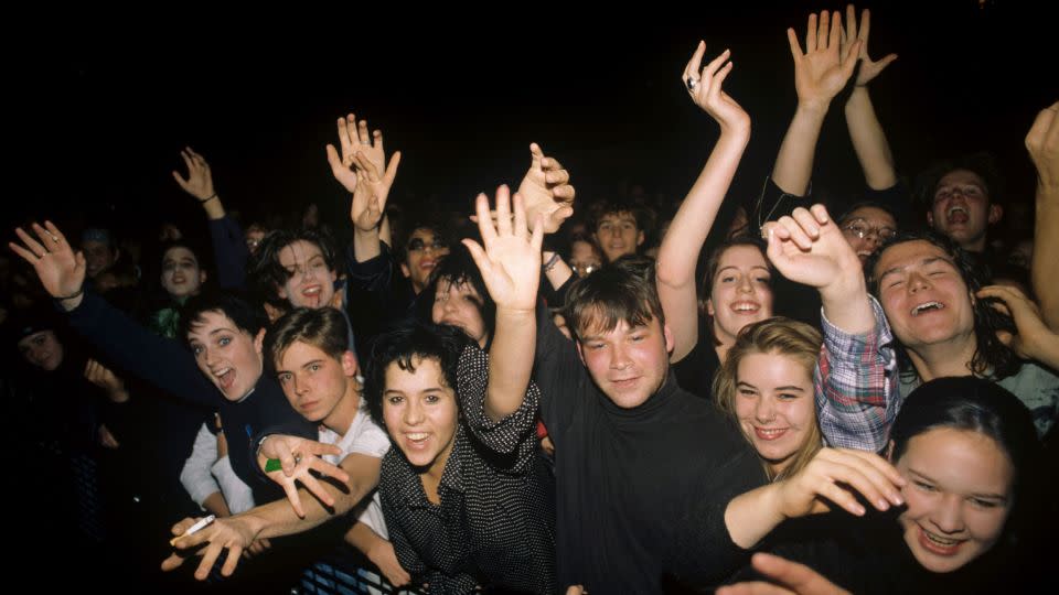 Fans of The Cure at a 1992 concert smile and dance, proving goths are prone to bouts of joy. - Fryderyk Gabowicz/picture alliance/Getty Images