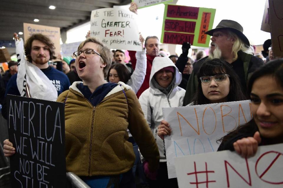 Natalie Swarts of Philadelphia calls out protest chants as the crowd follows in cadence during a protest of President Donald Trump's travel ban on refugees and citizens of seven Muslim-majority nations, Sunday, Jan. 29, 2017, at Philadelphia International Airport in Philadelphia. (AP Photo/Corey Perrine)