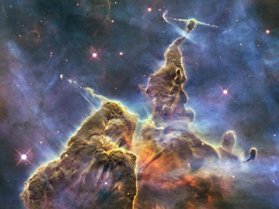 A more recent image captured by Hubble shows chaotic activity atop a three-light-year-tall pillar of gas and dust that is being eaten away by the brilliant light from nearby bright stars in a tempestuous stellar nursery called the Carina Nebula (Nasa/ESA/STScI)