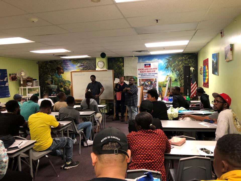 Employees from Uneeda Enterprizes in Spring Valley explain the kinds of jobs that are available there to new immigrants during an Oct. 3, 2023 jobs fair at Konbit Neg Lakay in the village.