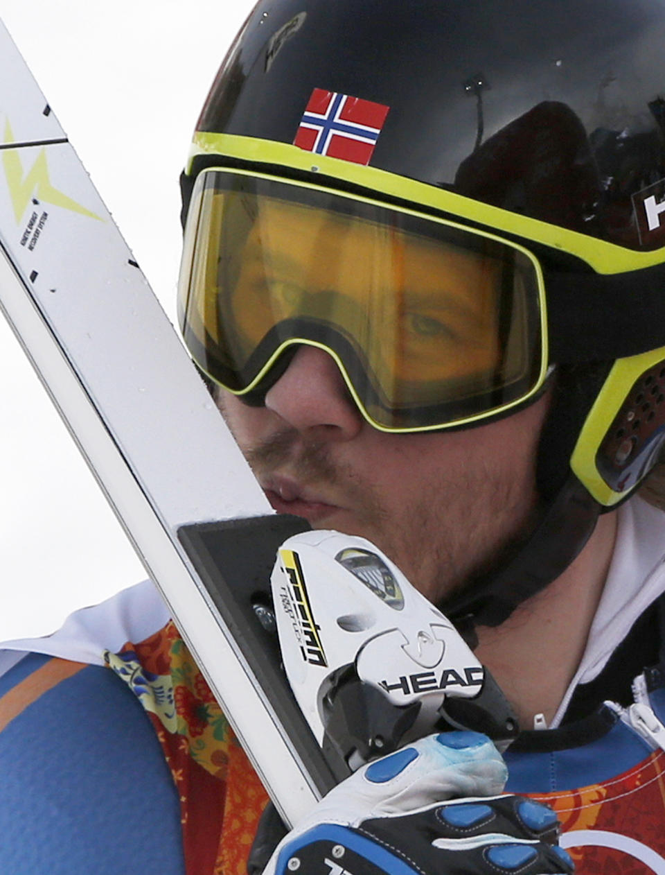 Norway's Kjetil Jansrud kisses his ski after his run in the men's super-G at the Sochi 2014 Winter Olympics, Sunday, Feb. 16, 2014, in Krasnaya Polyana, Russia.(AP Photo/Christophe Ena)