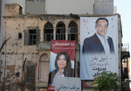Posters of Lebanese parliament candidates Rania Shmaitilly and Nabil Bader are seen on a building in Beirut, Lebanon April 23, 2018. REUTERS/ Mohamed Azakir