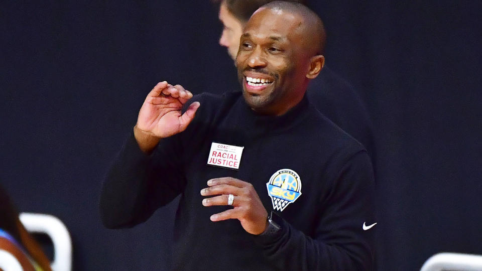 Seen here, WNBA coach James Wade gestures happily on the sideline.