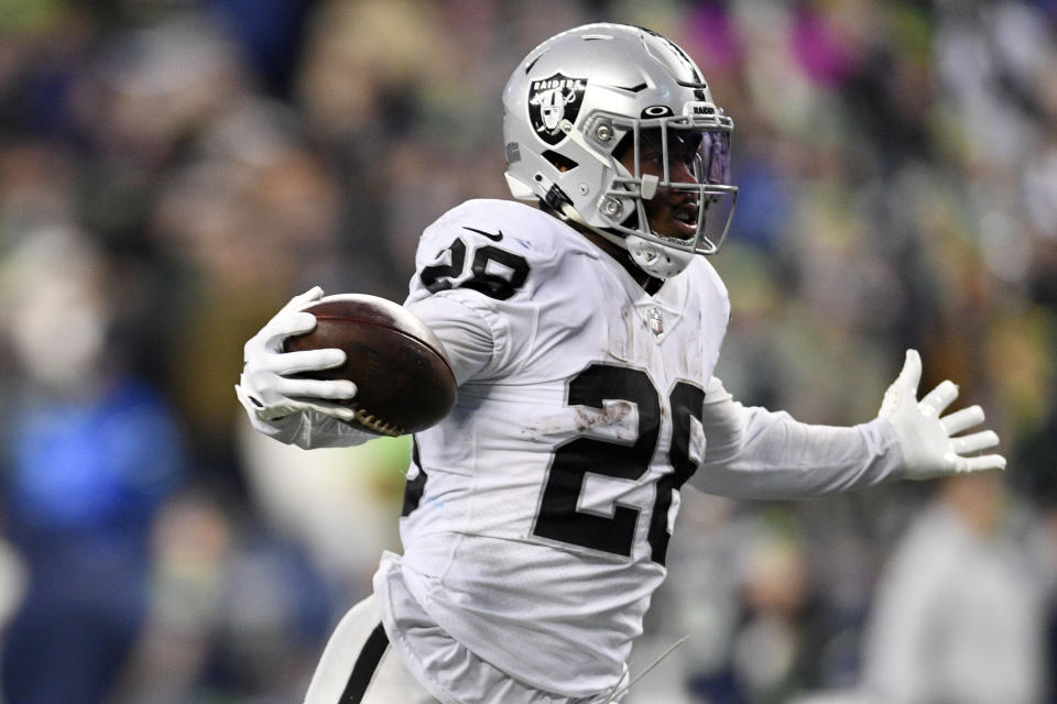 Las Vegas Raiders running back Josh Jacobs (28) celebrates as he scores the game-winning touchdown during overtime of an NFL football game against the Seattle Seahawks Sunday, Nov. 27, 2022, in Seattle. (AP Photo/Caean Couto)