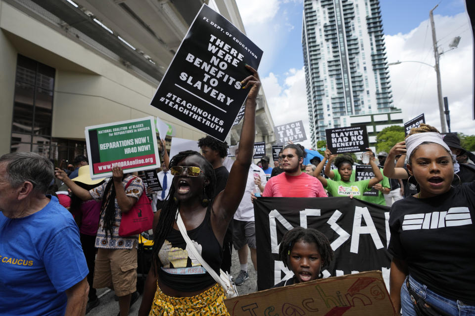 People chat slogans during the "Teach No Lies" march to the School Board of Miami-Dade County to protest Florida's new standards for teaching Black history, which have come under intense criticism for what they say about slavery, Wednesday, Aug. 16, 2023, in Miami. (AP Photo/Lynne Sladky)