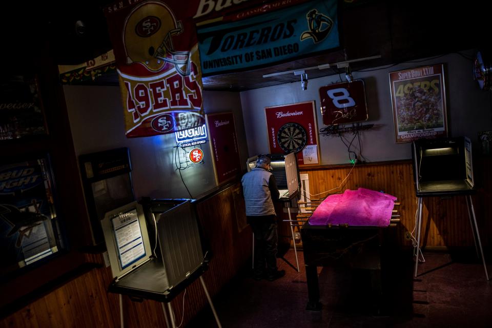 A voter casts a ballot at a polling station in Friends Bar on November 3, 2020 in San Francisco, California.