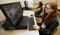 Claire Hofstra, foreground, and Kaila Morris play "Heroes of the Storm," at Hathaway Brown School, Wednesday, July 10, 2019, in Shaker Heights, Ohio. Hathaway Brown launched the country's first varsity esports program at an all-girls school. Coach J Collins hopes to encourage more girls to stick with video games through their teenage years, something that might have a ripple effect across an industry grappling with gender disparity. (AP Photo/Tony Dejak)