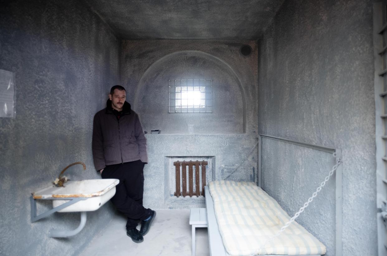 Oleg Navalny, the brother of Alexei Navalny, stands inside a replica, constructed in Berlin, of his brother's punishment cell in a Russian penal colony.