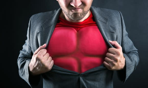 A man opens his blazer revealing a bulletproof vest.