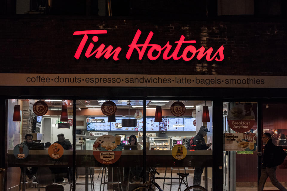 Picture of a sign with the logo of Tim Hortons on their main cafe for downtown Toronto, Ontario, Canada. Tim Horton's is a multinational fast food restaurant known for its coffee and donuts. It is also Canada's largest quick service restaurant chain
