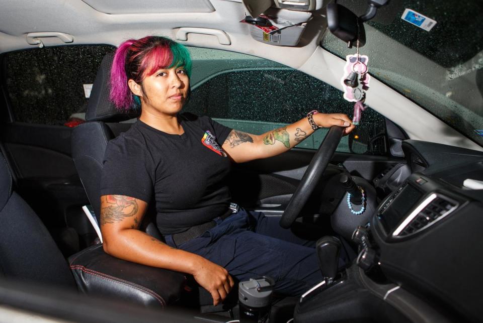 Claudia Cadena, an EMT at Austin-Travis County EMS, sits in her car at the end of a shift before commuting back to her home in San Antonio on Sept. 14, 2023.