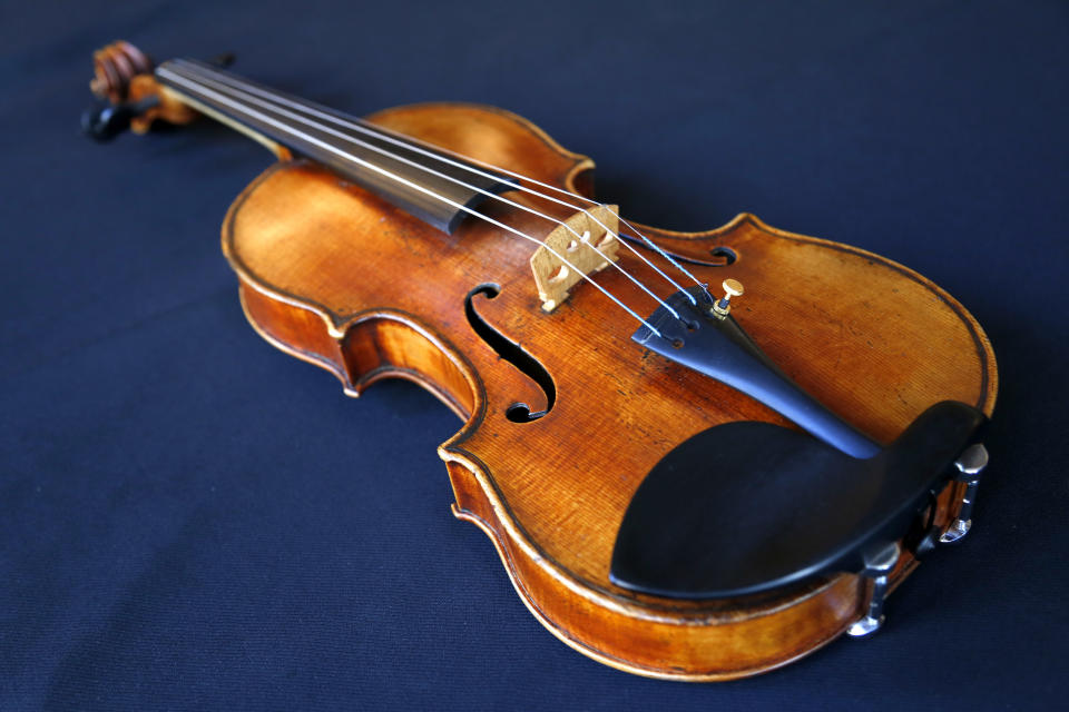 FILE - In this Wednesday, March 8, 2017 file photo, the Ames Stradivarius violin is seen in New York. The Stradivarius violin stolen four decades ago from the late virtuoso Roman Totenberg and returned to his family by a federal prosecutor came alive again _ at the crime scene, playing the same music. At a concert in Cambridge, Massachusetts, 19-year-old star violinist Nathan Meltzer revived the priceless instrument of the Polish-born musician on Friday evening, Nov. 15, 2019. (AP Photo/Seth Wenig, File)