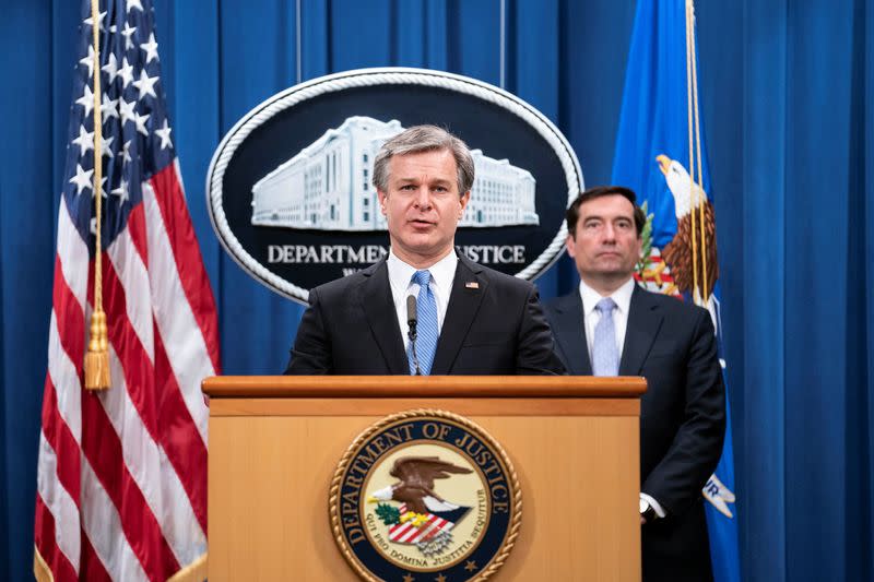 FBI Director Christopher Wray attends a virtual news conference at the Department of Justice in Washington