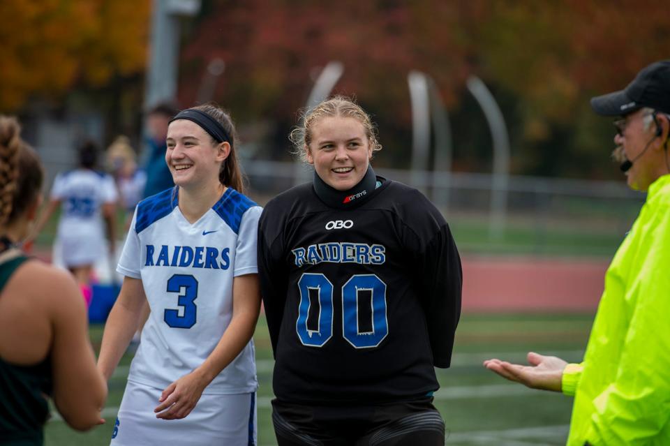 Dover-Sherborn Regional High School captains junior Drew Hussar, left, and  senior Caroline Harvey before the coin toss against Bishop Feehan, Oct. 17, 2022.  The game ended in a 1-1 tie.