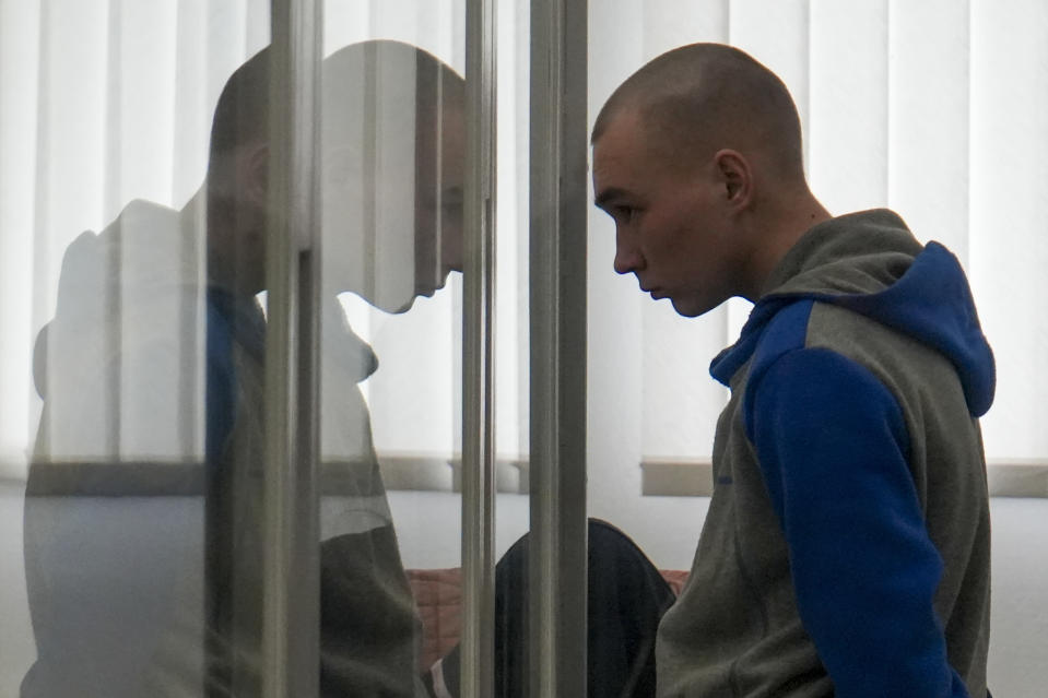 Russian Sgt. Vadim Shishimarin stands in court during a hearing in Kyiv, Ukraine, Thursday, May 19, 2022. The 21 year old Russian soldier facing the first war crimes trial since the start of the war in Ukraine testified Thursday that he shot a civilian on orders from two officers and pleaded for his victim's widow to forgive him. (AP Photo/Roman Hrytsyna)