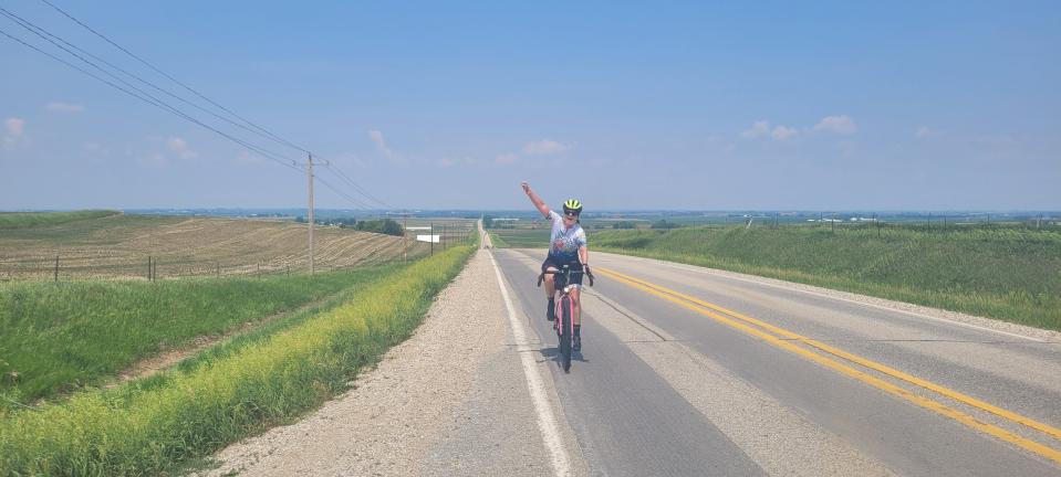 Kathy Murphy celebrates as she tops a hill between Lake View and Breda during the RAGBRAI route inspection Ride on Tuesday.