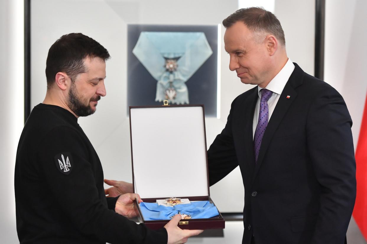 Polish President Andrzej Duda (R) awards Ukrainian President Volodymyr Zelensky with Order of the White Eagle during his visit in Warsaw, Poland (EPA)