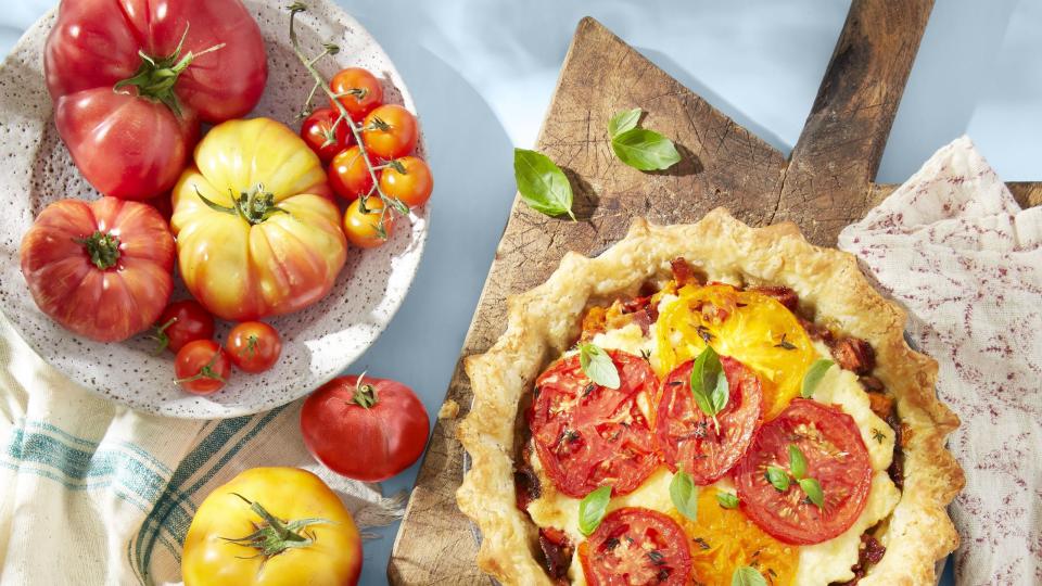 southern tomato pie with bacon on a wooden serving board