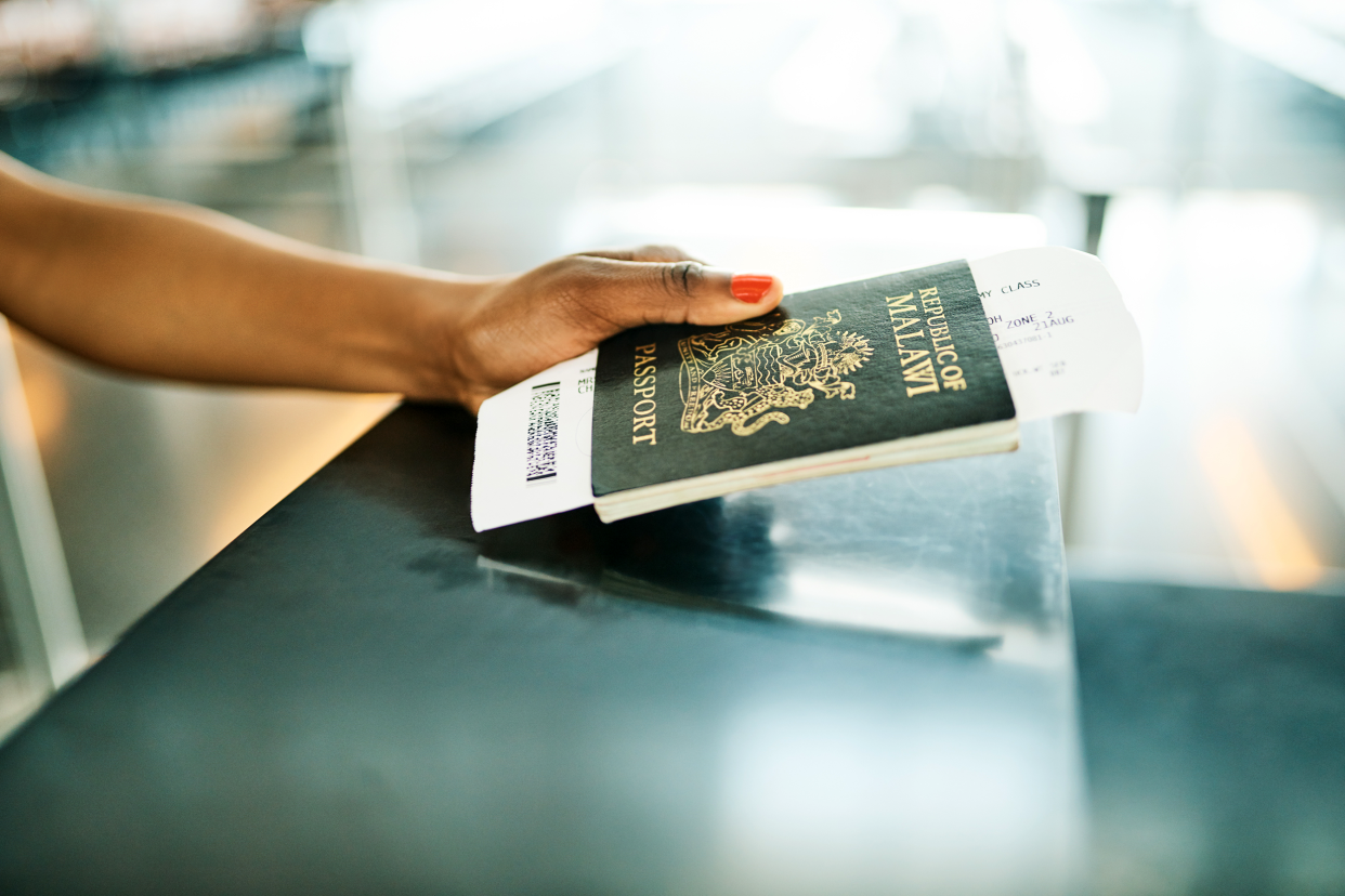 Handing passport over to airport desk