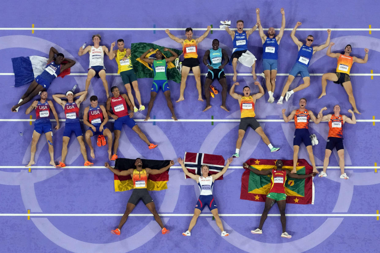 Bottom row from left: winners of the decathlon — silver medalist Leo Neugebauer, of Germany, gold medalist Markus Rooth, of Norway, and bronze medalist Lindon Victor, of Grenada — lie on the track with fellow competitors at the Summer Olympics in France on Saturday.