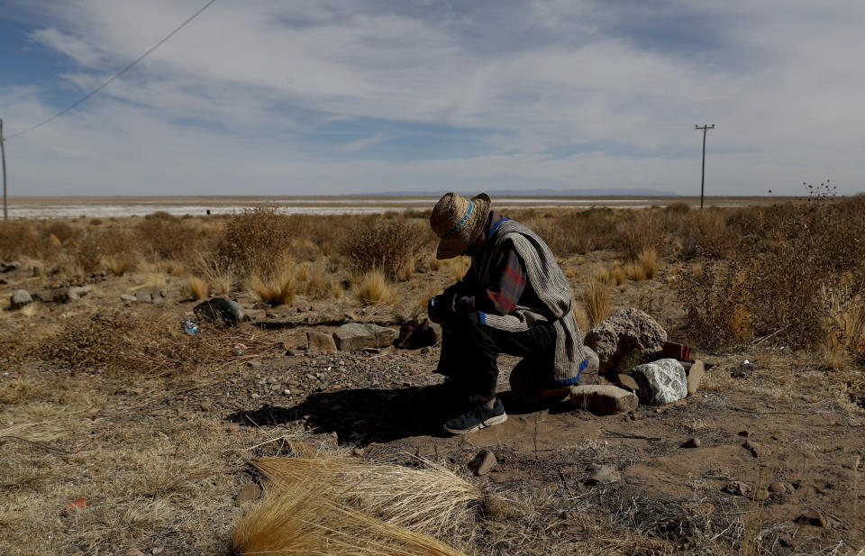 Rufino Choque, the mayor of the Urus del Lago Poopo indigenous community, waits for the arrival of instructors, in Punaca, Bolivia, Monday, May 24, 2021. Lago Poopo, Bolivia's second-largest lake, gave life to a rich culture since the first men set foot on the Altiplano but it dried up about five years ago. “We are ancient, but we have no territory. Now we have no source of work, nothing,” said Choque. (AP Photo/Juan Karita)