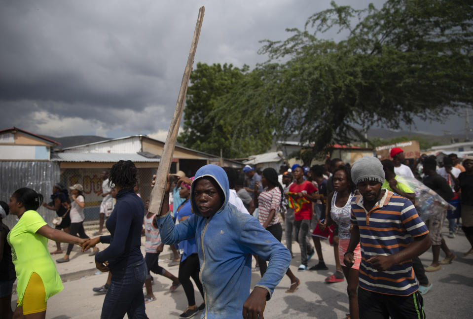 People protest for the release of kidnapped missionaries near the missionaries' headquarters in Titanyen, north of Port-au-Prince, Haiti, Tuesday, Oct. 19, 2021. A group of 17 U.S. missionaries including children was kidnapped by a gang in Haiti on Saturday, Oct. 16, according to a voice message sent to various religious missions by an organization with direct knowledge of the incident. (AP Photo/Joseph Odelyn)