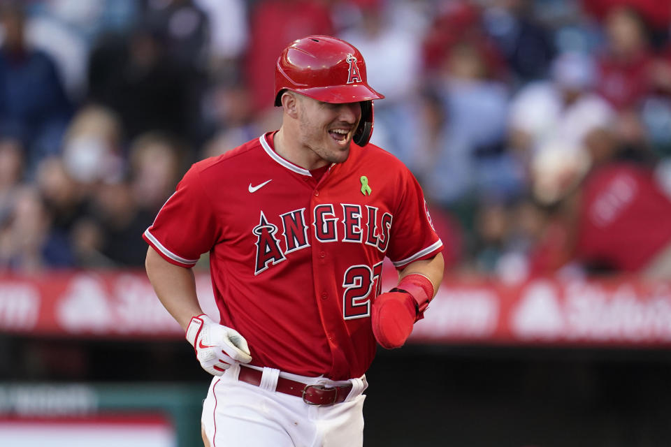 Los Angeles Angels' Mike Trout (27) runs to the dugout after scoring off of a single hit by Jared Walsh during the first inning of an MLB game