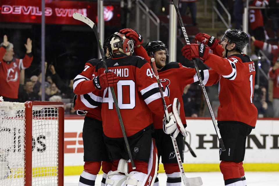 New Jersey Devils goaltender Akira Schmid celebrates with teammates after they defeated the New York Rangers in Game 7 of an NHL hockey Stanley Cup first-round playoff series Monday, May 1, 2023, in Newark, N.J. (AP Photo/Adam Hunger)