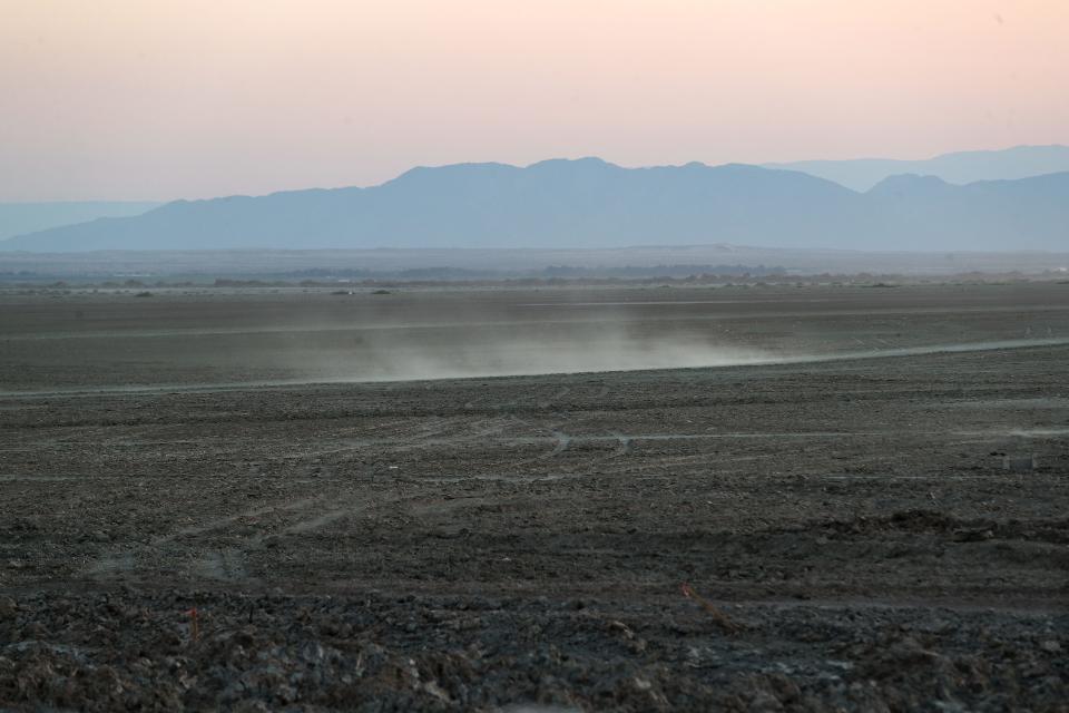 Dust blows across the landscape in an area of the Salton Sea that has dried out in the last few years.  This section is just east of the New River, June 20, 2021.