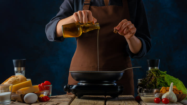 Pouring olive oil into pan