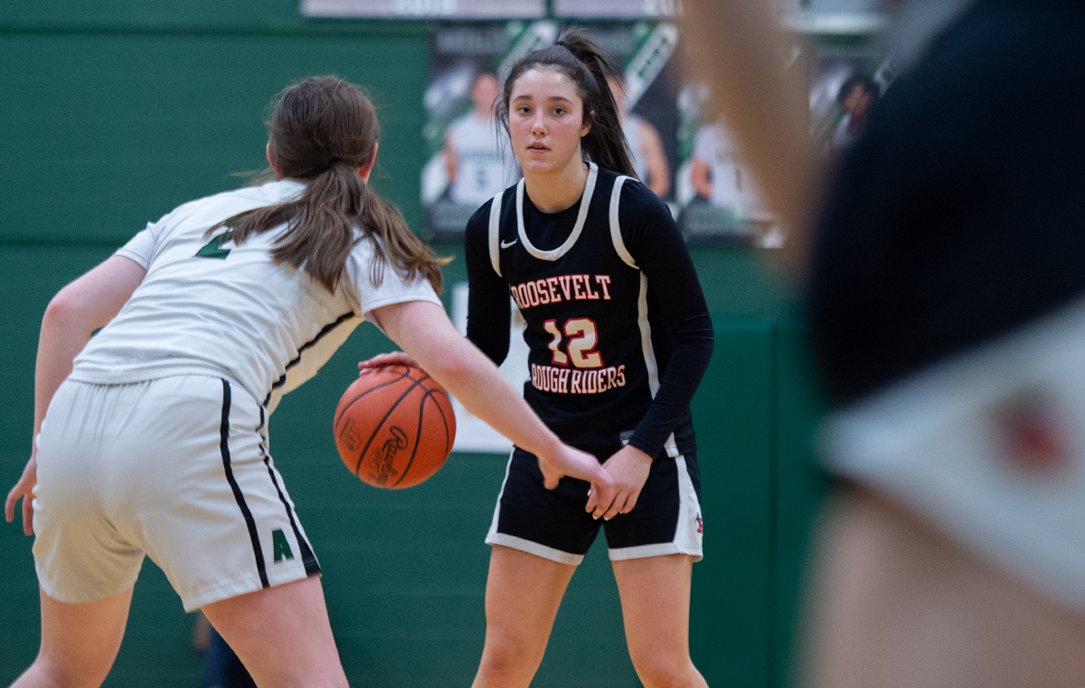 Roosevelt's Julia Nash dribbles the ball with Aurora's Sam Stask defending last year.